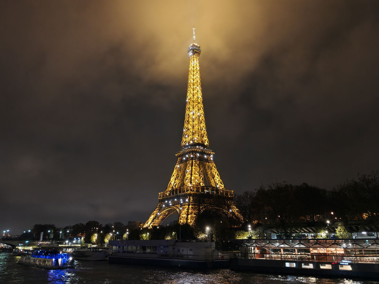 The Eiffel Tower, at night, illuminated