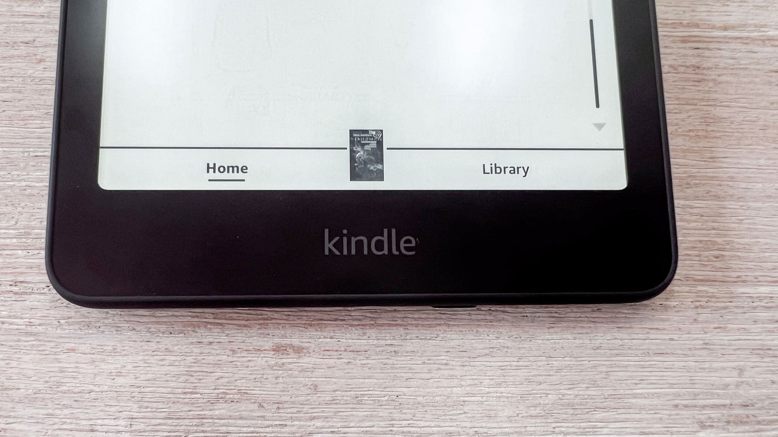 The Kindle branding on the broad lower bezel of the Amazon Kindle Paperwhite (2024)